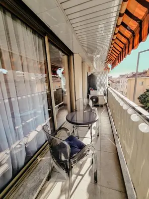 a table and chairs on the balcony of a building at Appartement centre Cannes Soleil - 2 rooms in Cannes
