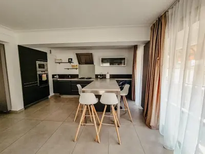 a kitchen with a table and chairs in a room at Appartement centre Cannes Soleil - 2 rooms in Cannes