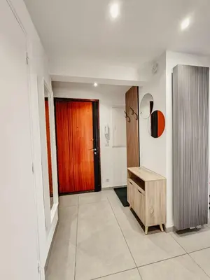 a hallway with a wooden door and a wooden bench at Appartement centre Cannes Soleil - 2 rooms in Cannes