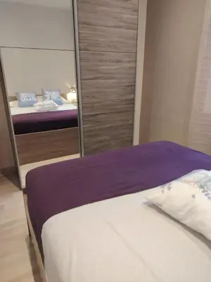 a bedroom with a mirror next to a bed at Cannes centre T3 Carré D'Or calme air conditionné WiFi in Cannes