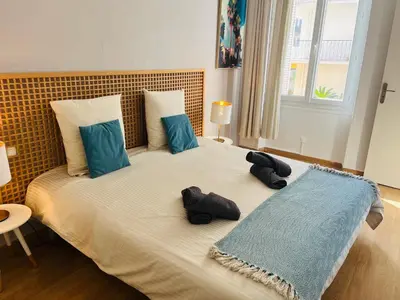 a bedroom with a bed with two stuffed animals on it at Appartement centre-ville à 5 min du palais des festivals in Cannes