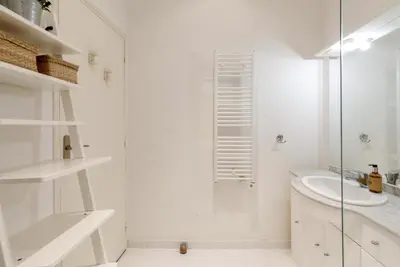 a white bathroom with a shower and a sink at Appartement centre-ville à 5 min du palais des festivals in Cannes
