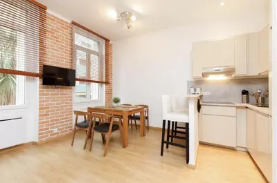 a kitchen and dining room with a table and a counter at Appartement centre-ville à 5 min du palais des festivals in Cannes