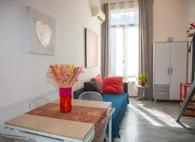 a living room with a blue couch and a table at Sweet Holiday by Connexion in Cannes