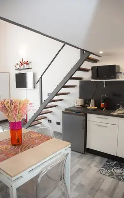 a kitchen with a dining table and a staircase at Sweet Holiday by Connexion in Cannes