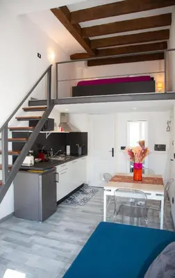 a kitchen and dining room with a loft bed at Sweet Holiday by Connexion in Cannes