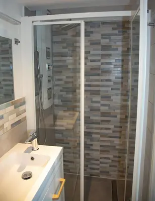 a bathroom with a shower and a white sink at Sweet Holiday by Connexion in Cannes