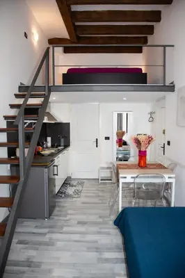 a kitchen and dining room with a staircase in a house at Sweet Holiday by Connexion in Cannes