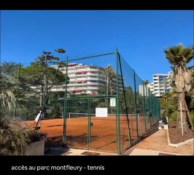 a tennis court with a tennis court net at Terrasse Clim Wifi Parking 10 min à pieds de la Croisette in Cannes