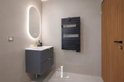 a bathroom with a sink and a mirror at Les Lucioles 3 - Luxury Studio Apartment in Cannes