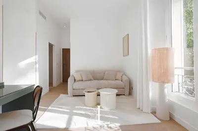 a living room with a couch and a table at Les Lucioles 3 - Luxury Studio Apartment in Cannes