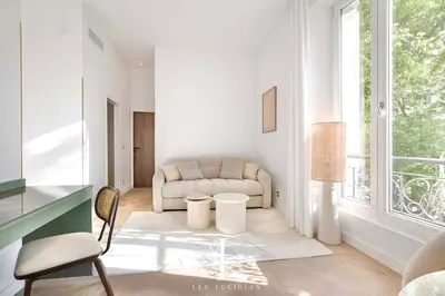 a white living room with a couch and a window at Les Lucioles 3 - Luxury Studio Apartment in Cannes