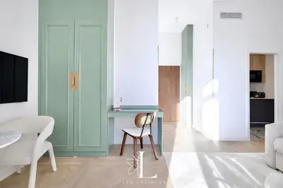 a living room with green walls and a chair at Les Lucioles 3 - Luxury Studio Apartment in Cannes