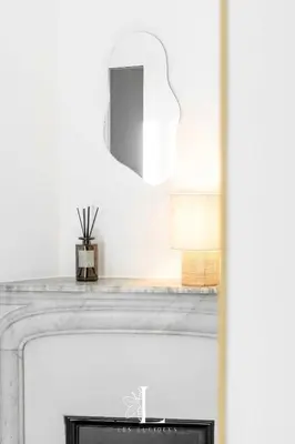 a fireplace with a mirror on top of it at Les Lucioles 3 - Luxury Studio Apartment in Cannes