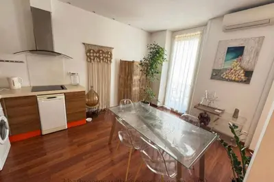 a kitchen with a table and chairs in a room at One bedroom with balcony Rue Chabaud in Cannes