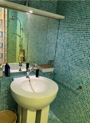 a bathroom with a white sink and a mirror at One bedroom with balcony Rue Chabaud in Cannes