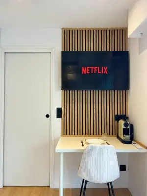 a white desk with a chair and a netflix sign at Charmant studio avec grande terrasse in Cannes