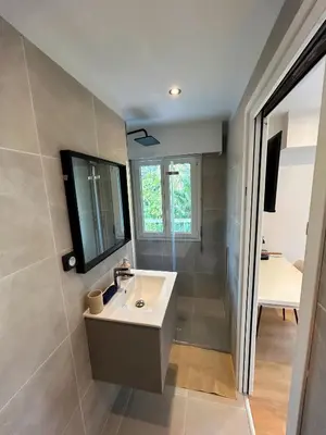 a bathroom with a sink and a mirror at Charmant studio avec grande terrasse in Cannes