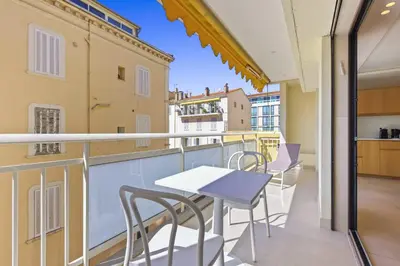 a balcony with a table and chairs on a building at REF 2021 -Cannes Centre Croisette - Apartment for rent in Cannes