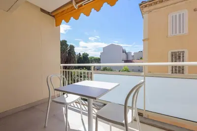 a table and chairs on a balcony with a view at REF 2021 -Cannes Centre Croisette - Apartment for rent in Cannes