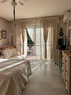a bedroom with a bed and a large window at Cozy Cannes Studio - 12 Min Walk To The Beach - Free Parking in Cannes