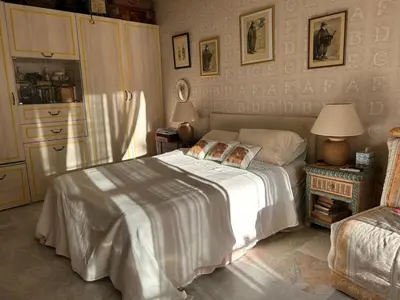 a bedroom with a bed with a white blanket at Cozy Cannes Studio - 12 Min Walk To The Beach - Free Parking in Cannes
