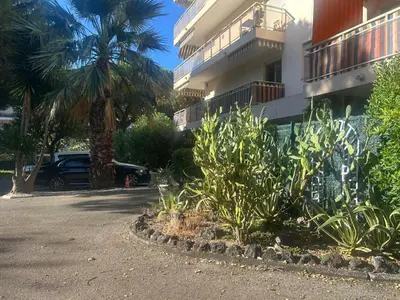 a parking lot with plants in front of a building at Cozy Cannes Studio - 12 Min Walk To The Beach - Free Parking in Cannes