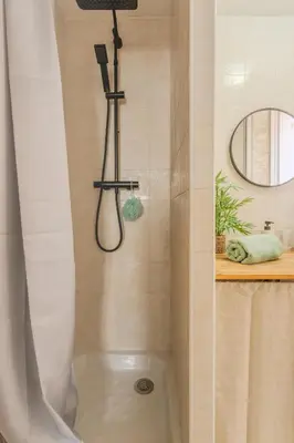 a bathroom with a black sink and a mirror at Brise de Sauge 1BR cosy clim, proche Palais in Cannes