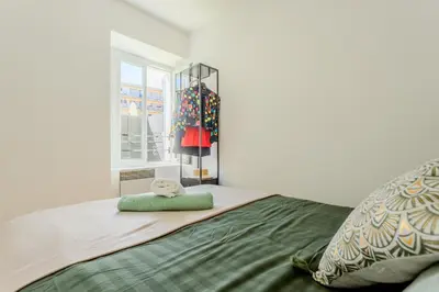 a bathroom with a shower curtain and a mirror at Brise de Sauge 1BR cosy clim, proche Palais in Cannes