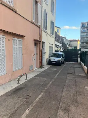 a bedroom with a bed and a wooden wall at Brise de Sauge 1BR cosy clim, proche Palais in Cannes