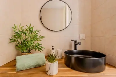 a table with plates and bowls on top of it at Brise de Sauge 1BR cosy clim, proche Palais in Cannes