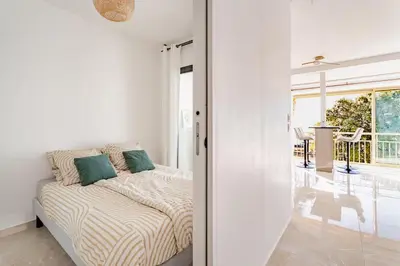 a bedroom with a bed and a sliding glass door at Luxury Apartment with Sea View and Private Beach Access in Cannes