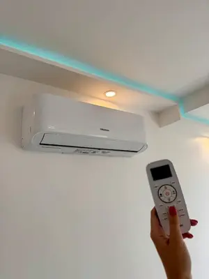 a person holding a remote control in a ceiling at Luxury Apartment with Sea View and Private Beach Access in Cannes
