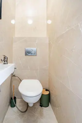 a bathroom with a toilet and a sink at Luxury Apartment with Sea View and Private Beach Access in Cannes