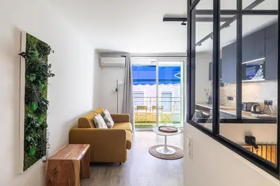 a living room with a couch and a table at 13 PRAD - Renovated apartment for 3 travelers near Croisette in Cannes