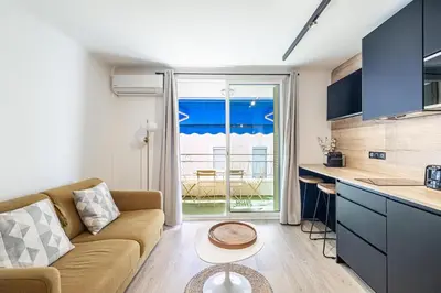 a kitchen and living room with a couch and a table at 13 PRAD - Renovated apartment for 3 travelers near Croisette in Cannes