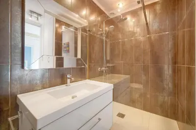 a bathroom with a white sink and a mirror at Studio Cannes Centre 2 min from La Croisette in Cannes