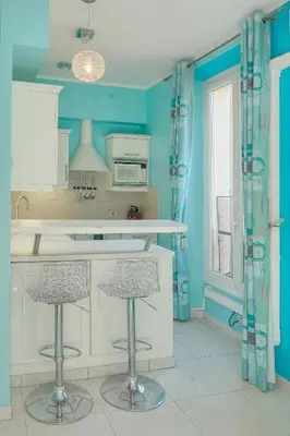 a kitchen with blue walls and two bar stools at Studio Cannes Centre 2 min from La Croisette in Cannes