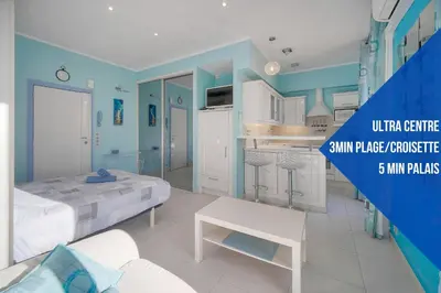 a blue and white room with a bed and a kitchen at Studio Cannes Centre 2 min from La Croisette in Cannes