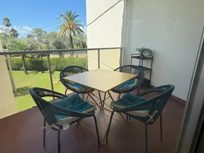a table and four chairs on a balcony with a table and chairs at Studio lumineux, terrasse, clim, parking, centre ville in Cannes