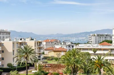 a view of a city with palm trees and buildings at Apartment Near Beach With Sea View 2 Terraces! in Cannes