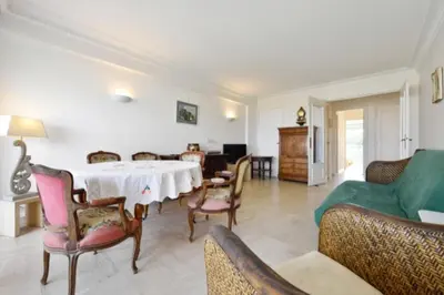a living room with a table and chairs at Apartment Near Beach With Sea View 2 Terraces! in Cannes