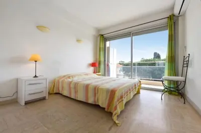 a bedroom with a bed and a large window at Apartment Near Beach With Sea View 2 Terraces! in Cannes