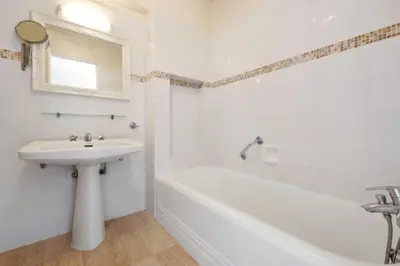 a white bathroom with a sink and a bath tub at Apartment Near Beach With Sea View 2 Terraces! in Cannes