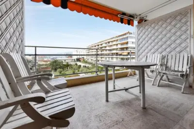 a balcony with chairs and a table and a view at Apartment Near Beach With Sea View 2 Terraces! in Cannes