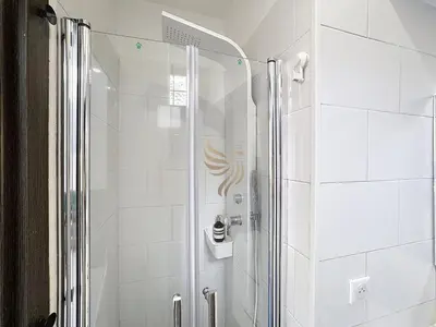 a shower with a glass door in a bathroom at Studio l'Atelier – Parking & Beaches 15 min Walk in Cannes