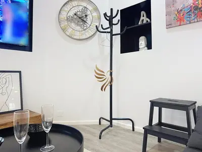 a room with two wine glasses and a clock on the wall at Studio l'Atelier – Parking & Beaches 15 min Walk in Cannes