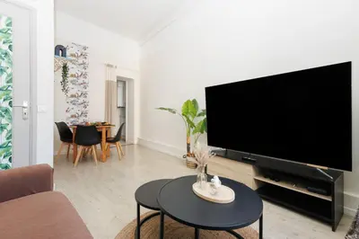 a living room with a large flat screen tv at Le Nova - 2 chambres, Parking privé, Centre ville in Cannes
