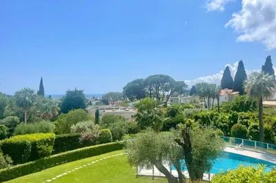 a view of a garden and a swimming pool at Cozy flat with terrace and swimming pool in Cannes in Cannes