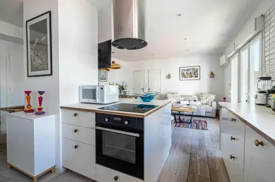 a kitchen with white cabinets and a stove top oven at Superb flat - 2BR- 4 P - Cannes in Cannes